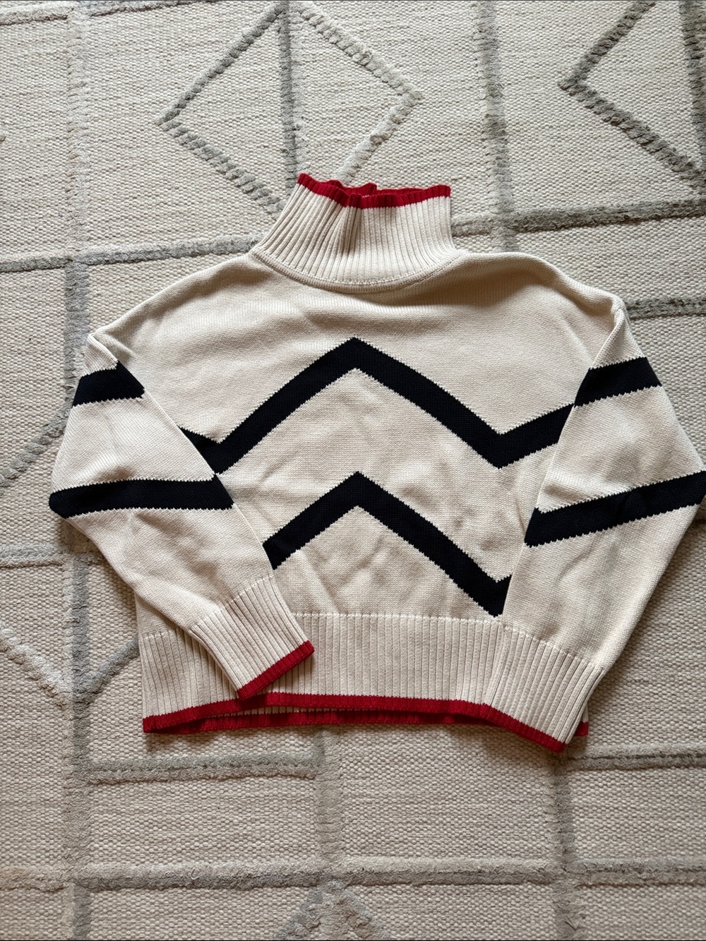 Cream Chevron Turtleneck Sweater with Black Stripes and Red Trim